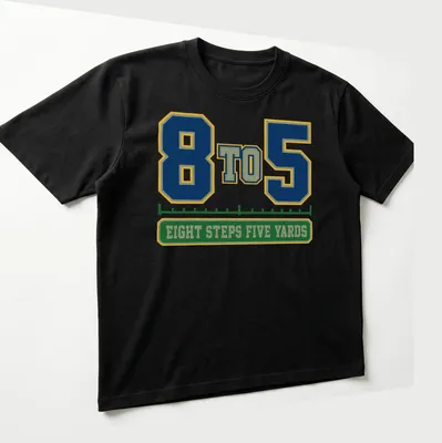 Varsity-style shirt featuring a marching band with bold lettering in navy, green, yellow, and white — printed on a unisex t-shirt (angled view)