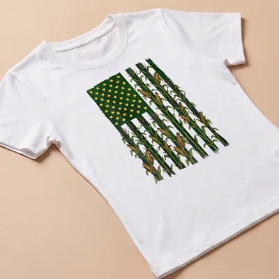Vintage distressed t-shirt with American Flag over a corn field graphic — printed on a women's shirt