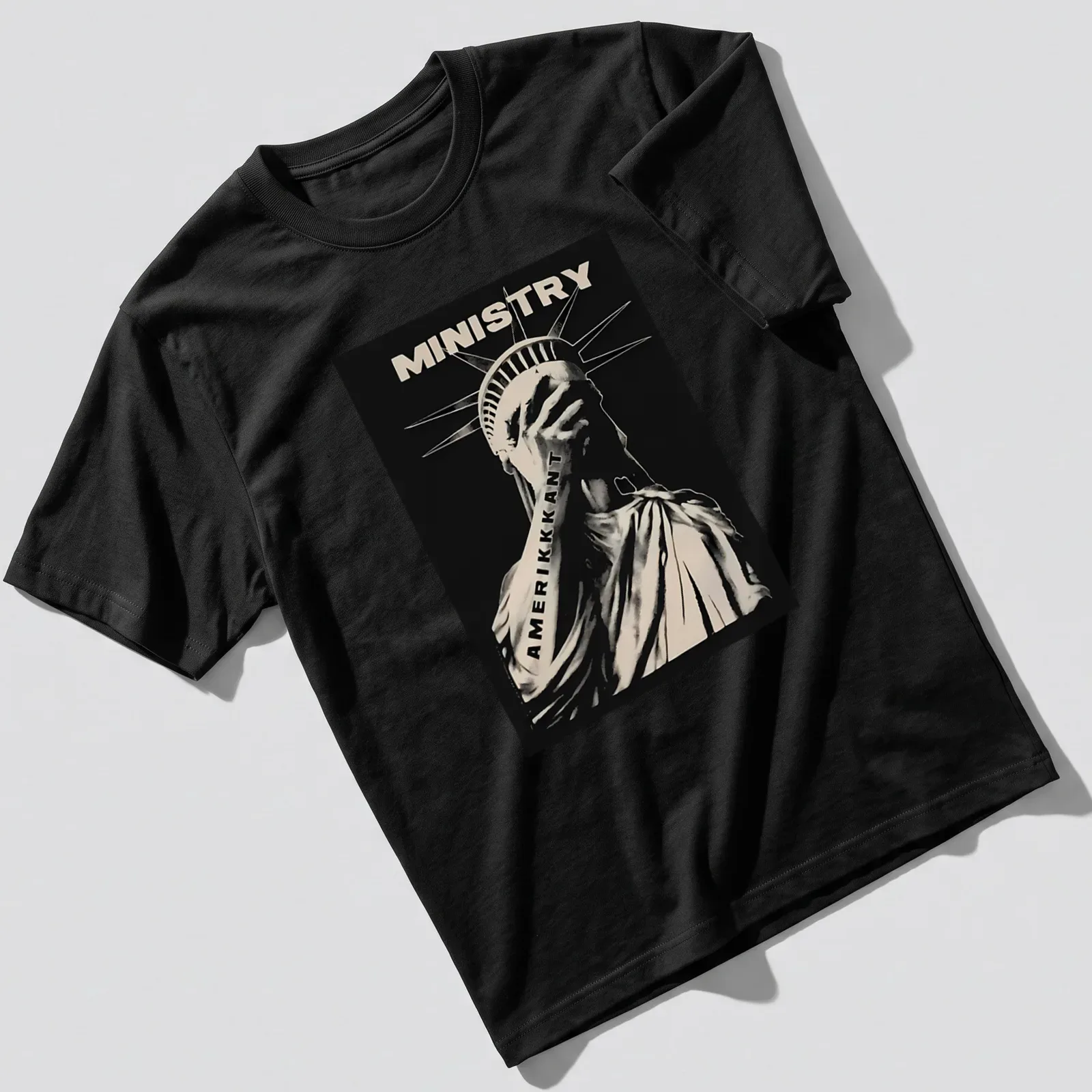 Monotone graphic of the Statue of Liberty with the text 'MINISTRY AMERIKKKANT' — printed on a unisex t-shirt