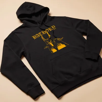 Bold retro design featuring a goat and the word BATHORY in orange and white — printed on a unisex hoodie