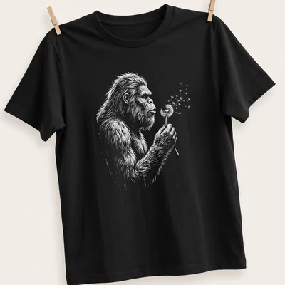 Vintage Bigfoot T-shirt with whimsical illustration of Sasquatch blowing dandelion seeds