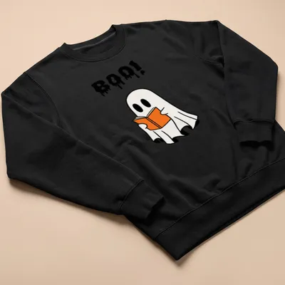 Cartoon ghost holding an orange book with the word Boo! above it — printed on a unisex sweatshirt