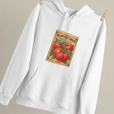 Vintage seed packet design featuring Brandywine tomatoes and classic typography — printed on a unisex hoodie