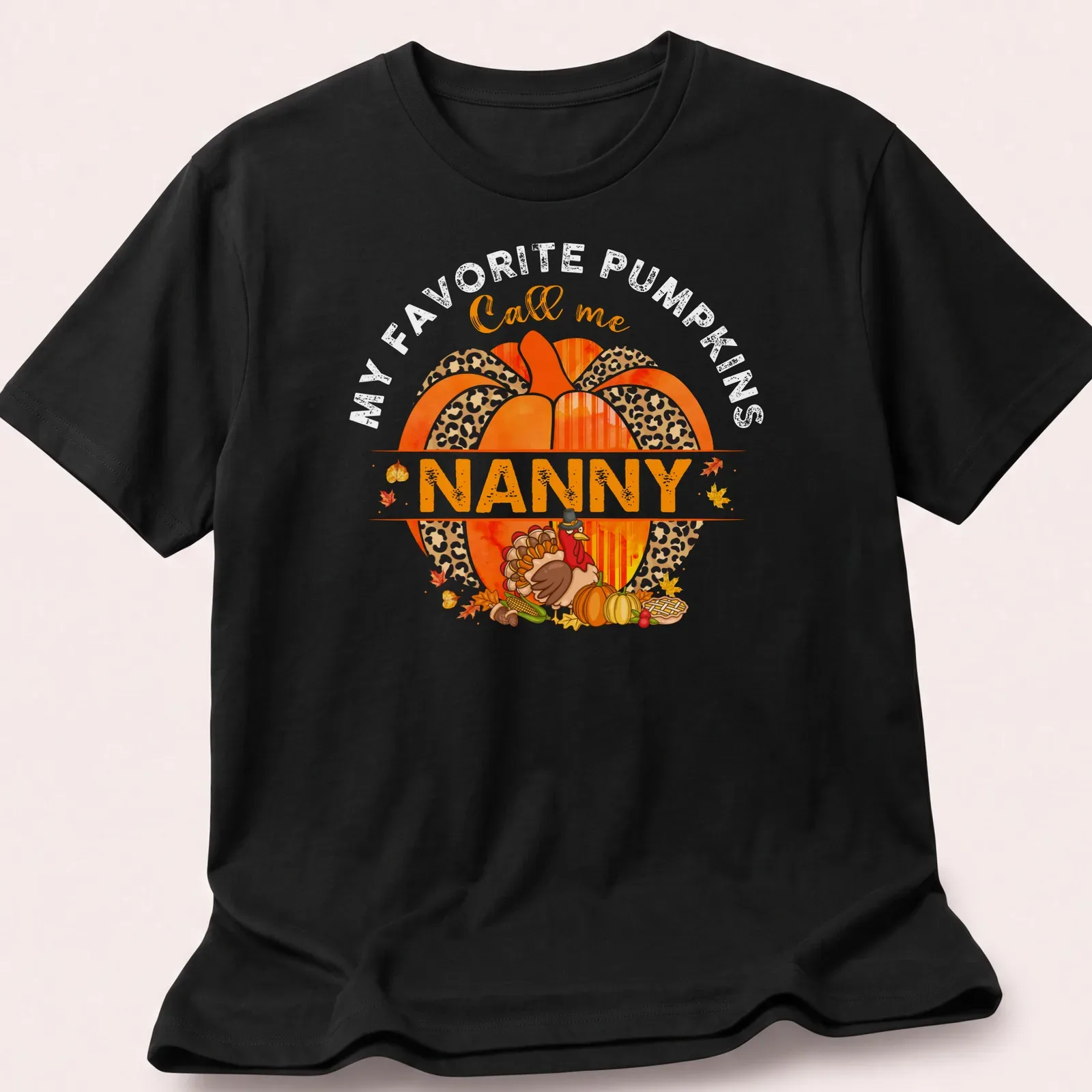 Watercolor design with a pumpkin and turkey above the text 'Call me Nanny' — printed on a unisex t-shirt