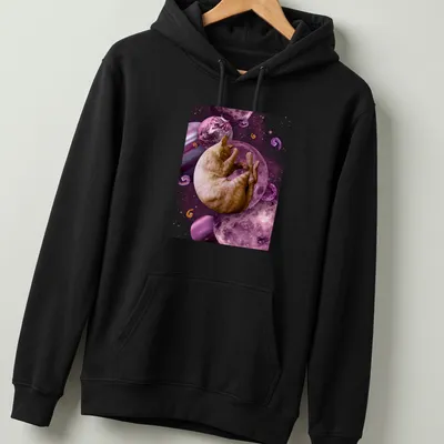 Illustration of a sleeping cat in space with cosmic elements in pink and purple. — printed on a unisex hoodie