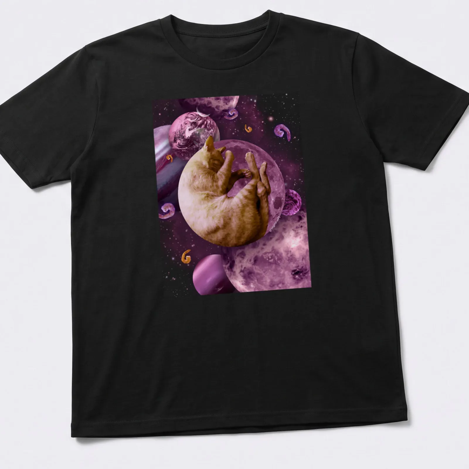 Illustration of a sleeping cat in space with cosmic elements in pink and purple. — printed on a unisex t-shirt