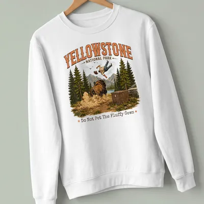 Vintage illustration of a person falling near bison with humorous text about fluffy cows — printed on a unisex sweatshirt