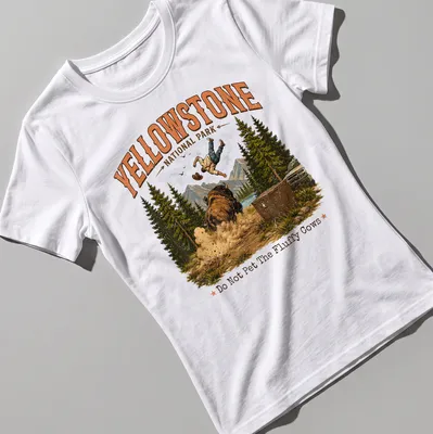 Vintage illustration of a person falling near bison with humorous text about fluffy cows — printed on a women's shirt
