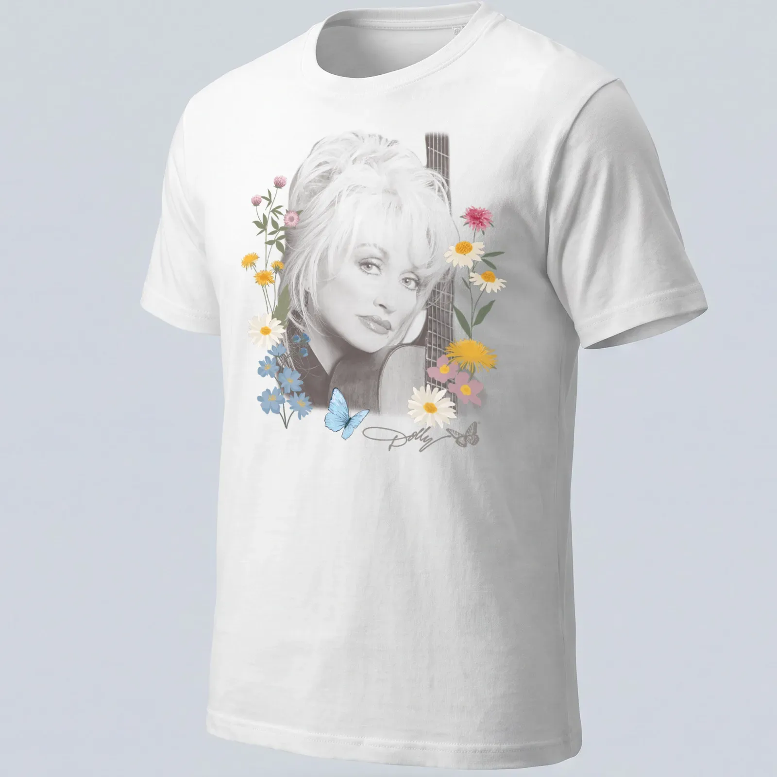 Dolly Parton portrait surrounded by flowers and butterflies in pastel colors — printed on a unisex t-shirt