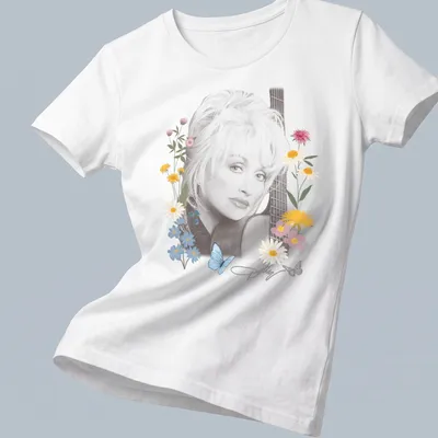 Dolly Parton portrait surrounded by flowers and butterflies in pastel colors — printed on a women's shirt