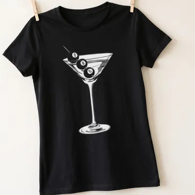Minimalist design of a martini glass with an eight ball garnish — printed on a women's shirt