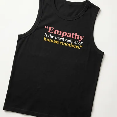 Bold typography with the phrase Empathy is the most radical of human emotions in colorful design. — printed on a tank top