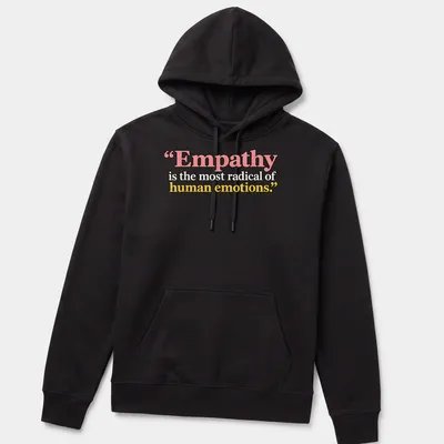 Bold typography with the phrase Empathy is the most radical of human emotions in colorful design. — printed on a unisex hoodie