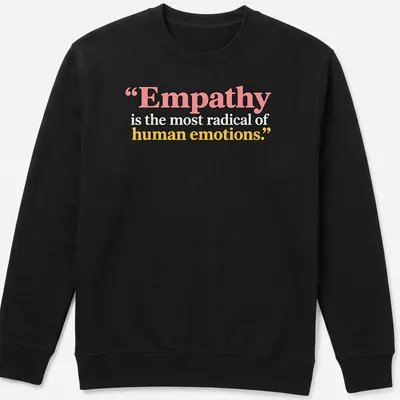 Bold typography with the phrase Empathy is the most radical of human emotions in colorful design. — printed on a unisex sweatshirt