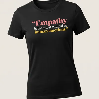 Bold typography with the phrase Empathy is the most radical of human emotions in colorful design. — printed on a women's shirt