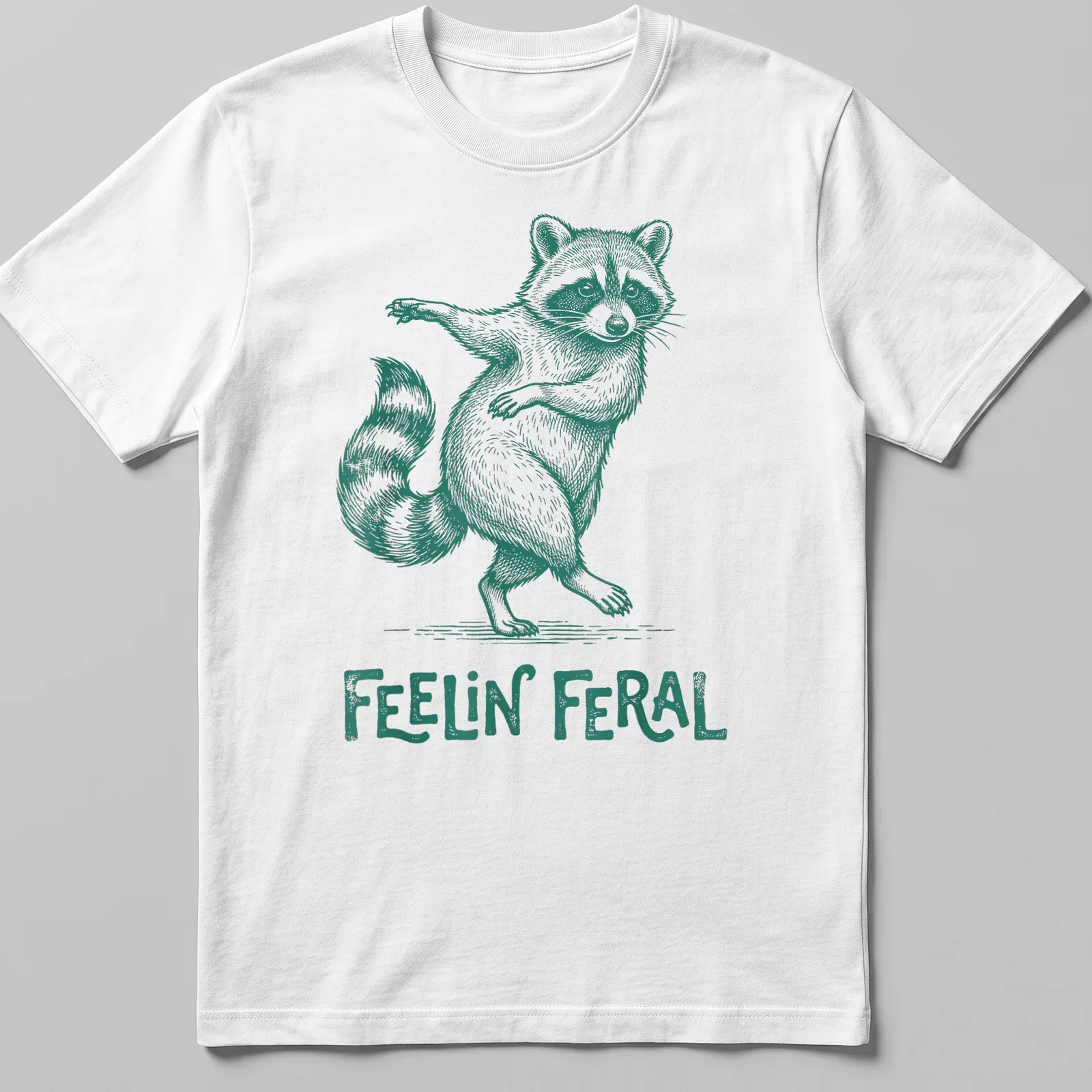 Green vintage illustration of a playful raccoon with the text 'Feelin' Feral' — printed on a unisex t-shirt