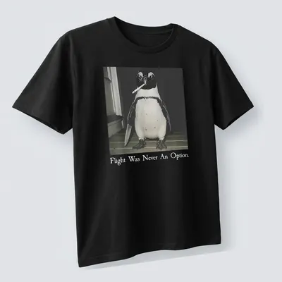 A humorous illustration of a smoking penguin with text about flying in black, white, and gray. — printed on a unisex t-shirt (angled view)