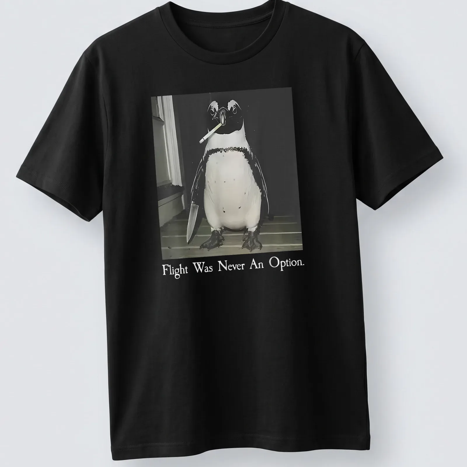 A humorous illustration of a smoking penguin with text about flying in black, white, and gray. — printed on a unisex t-shirt
