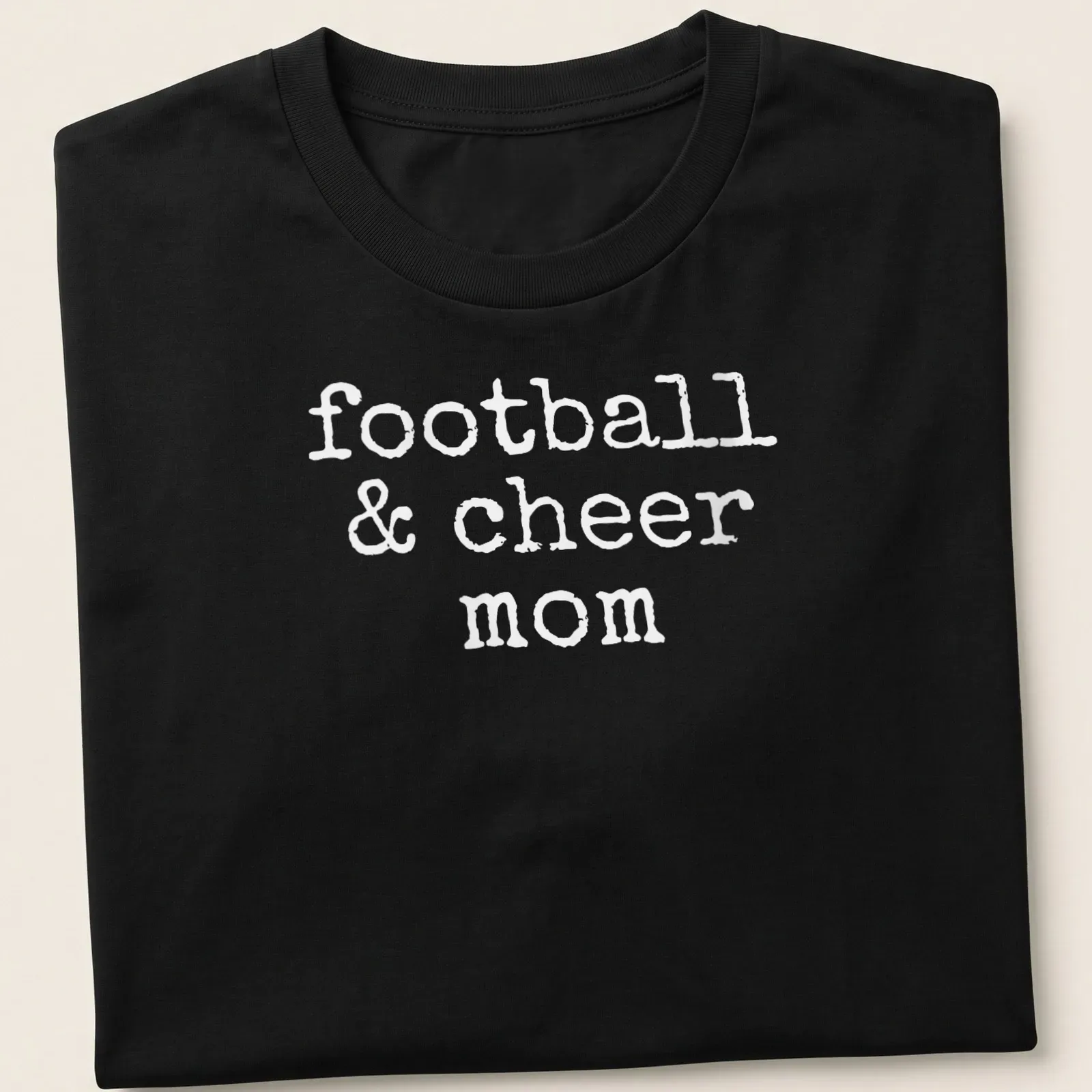 Playful typography of football & cheer mom T-shirt in bold white. — printed on a unisex t-shirt