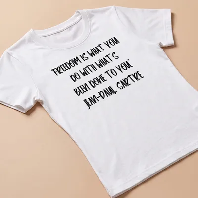 Bold handwritten text of Sartre's quote on freedom in black and white — printed on a women's shirt