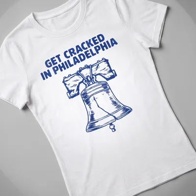 Illustration of the Liberty Bell with the phrase Get Cracked In Philadelphia in bold lettering. — printed on a women's shirt