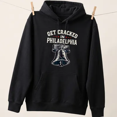 Vintage-style t-shirt featuring the Liberty Bell with humorous text about getting cracked in Philadelphia — printed on a unisex hoodie