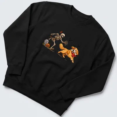 Cartoon Golden Retriever stealing a bone from a skeleton in Halloween colors — printed on a unisex sweatshirt