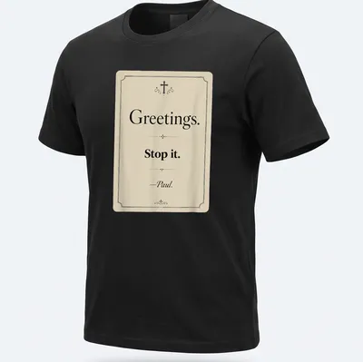 Vintage Christian humor tee with text reading 'Greetings. Stop it. —Paul.'