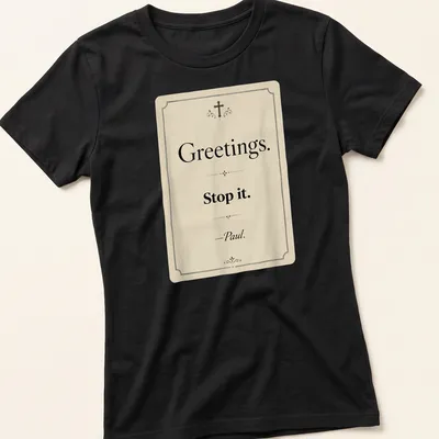 Vintage Christian humor tee with text reading 'Greetings. Stop it. —Paul.' — printed on a women's shirt