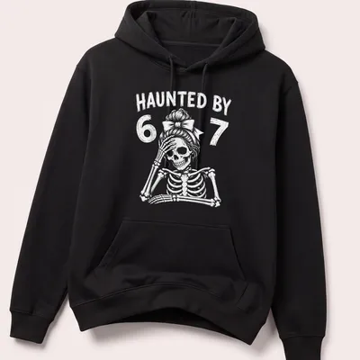 Cartoon skeleton teacher graphic with the text 'Haunted By 67' in black and white — printed on a unisex hoodie