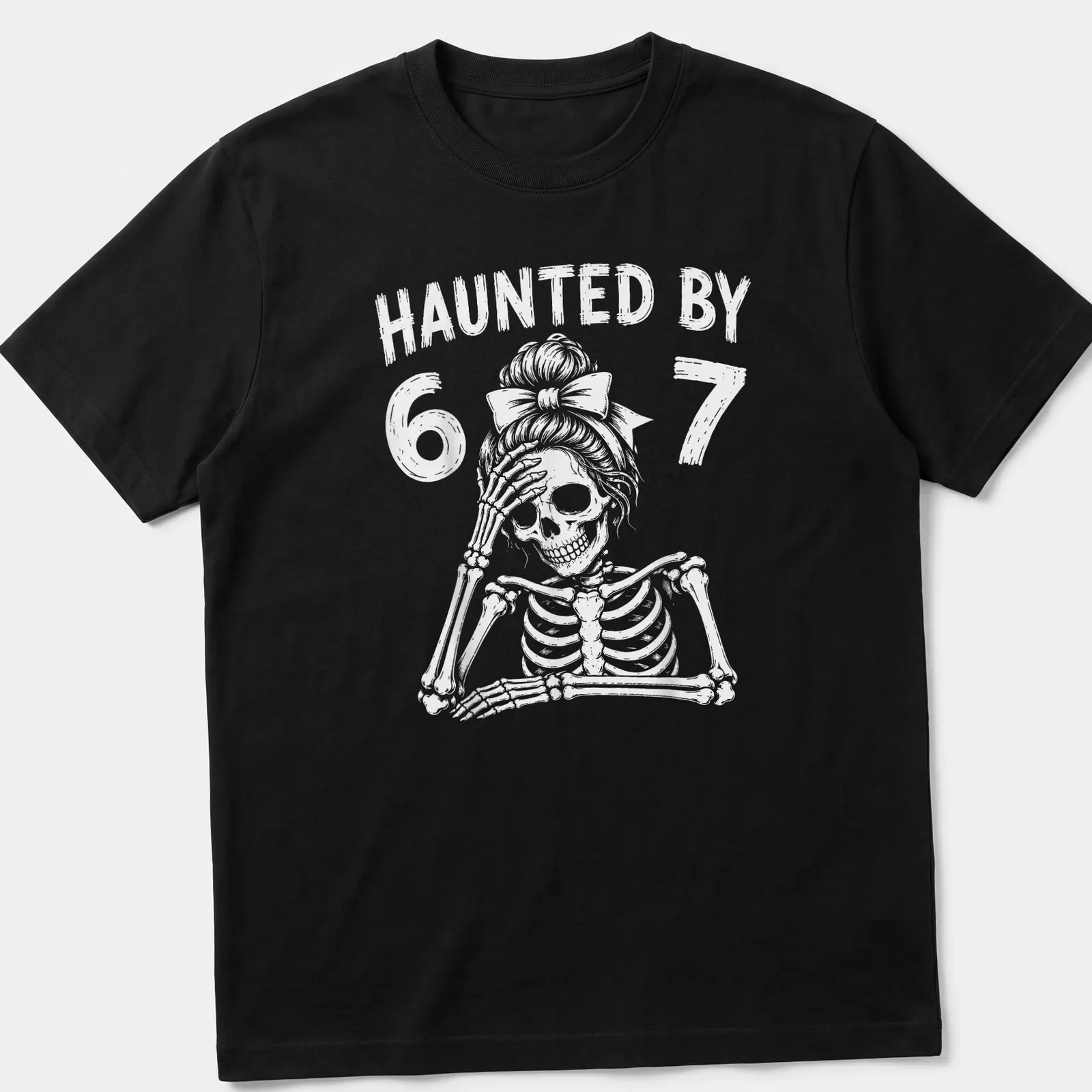 Cartoon skeleton teacher graphic with the text 'Haunted By 67' in black and white — printed on a unisex t-shirt