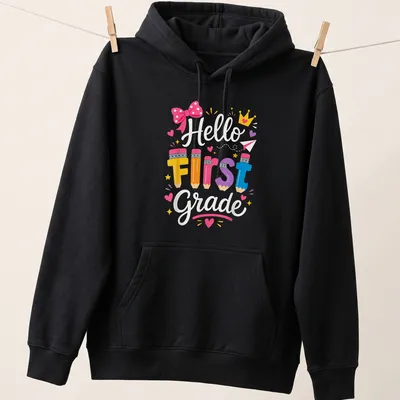 Colorful pencils surround the text 'Hello First Grade' in a playful design. — printed on a unisex hoodie