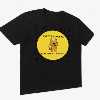 Kawaii cartoon dog design with bilingual text in yellow, black, and white — printed on a unisex t-shirt (angled view)