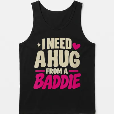Bold playful text saying 'I Need A Hug From A Baddie' in cream, pink, and red — printed on a tank top