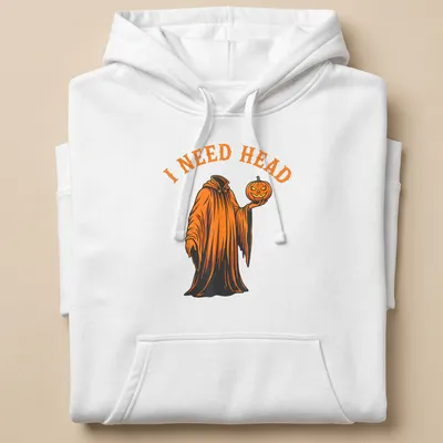 Cartoon ghost holding a pumpkin with 'I NEED HEAD' text in orange and black — printed on a unisex hoodie