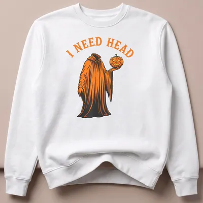 Cartoon ghost holding a pumpkin with 'I NEED HEAD' text in orange and black — printed on a unisex sweatshirt