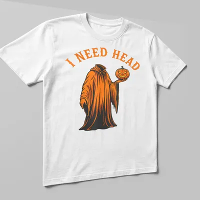 Cartoon ghost holding a pumpkin with 'I NEED HEAD' text in orange and black — printed on a unisex t-shirt (angled view)