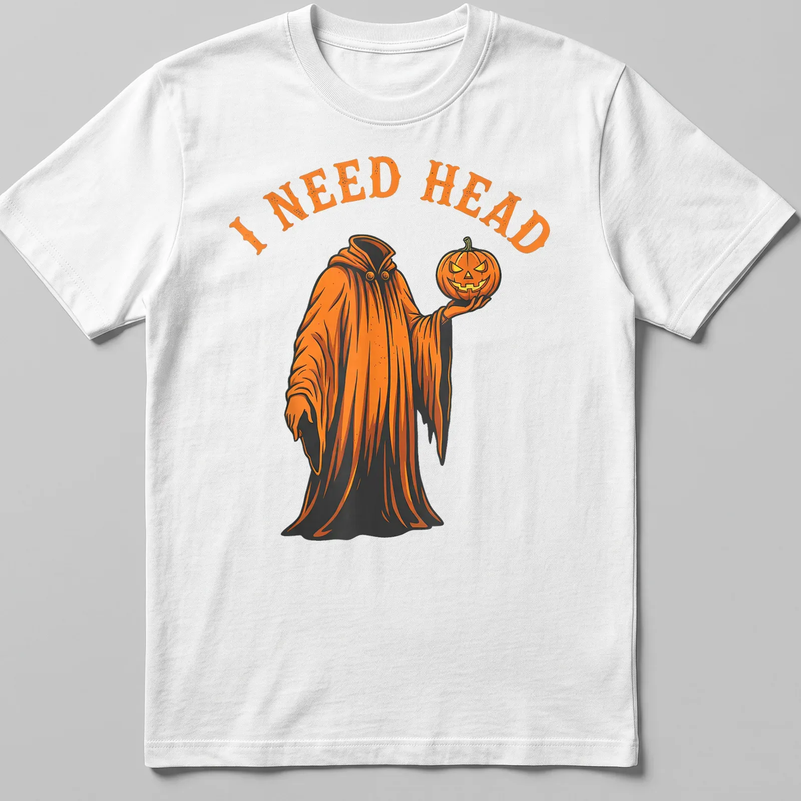 Cartoon ghost holding a pumpkin with 'I NEED HEAD' text in orange and black — printed on a unisex t-shirt