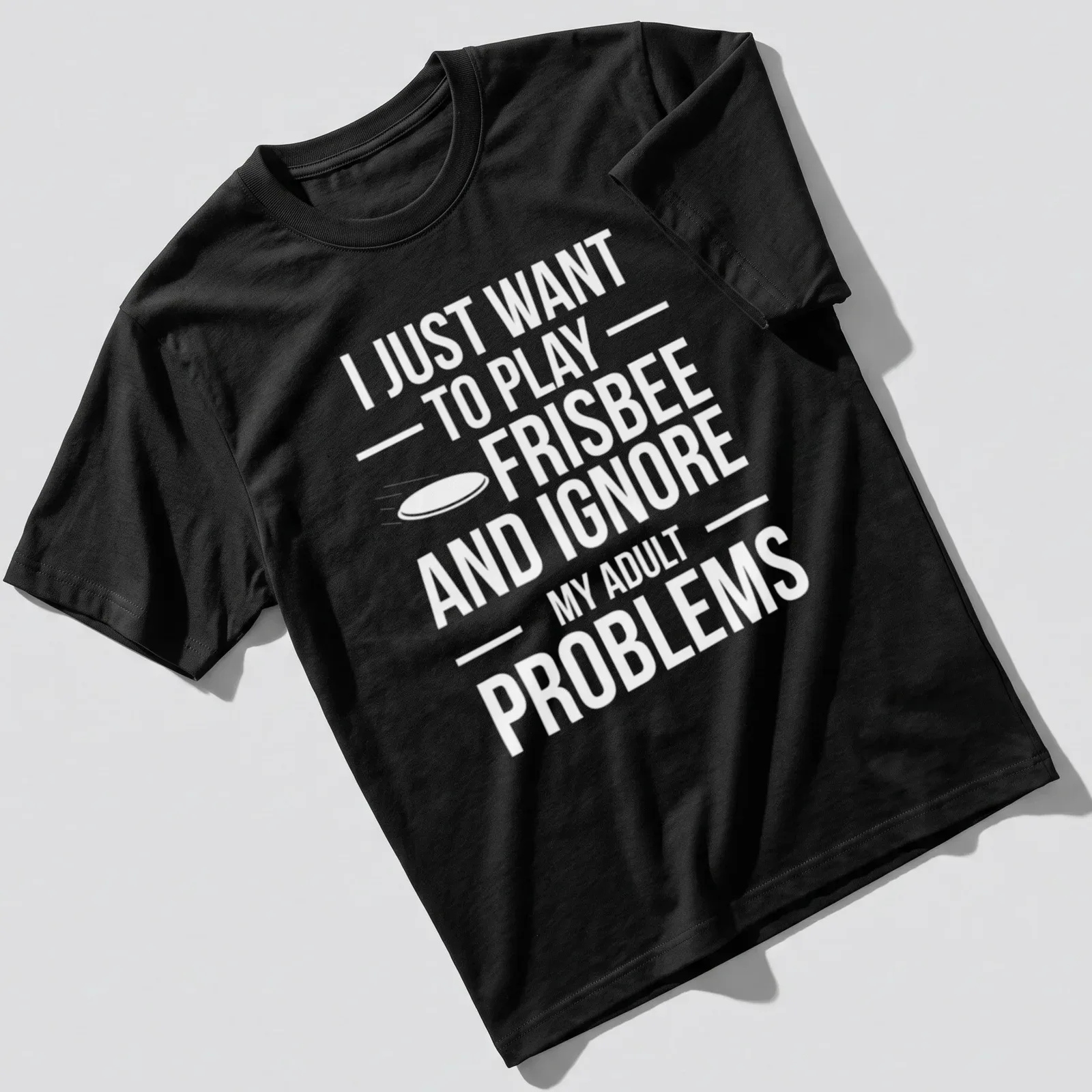 Bold typography t-shirt featuring a playful phrase about frisbee and ignoring adult problems — printed on a unisex t-shirt