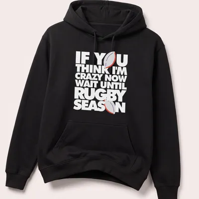 Minimalist print featuring a rugby ball with humorous text about rugby season — printed on a unisex hoodie