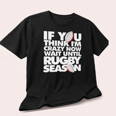 Minimalist print featuring a rugby ball with humorous text about rugby season — printed on a unisex t-shirt (angled view)