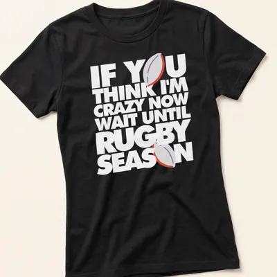 Minimalist print featuring a rugby ball with humorous text about rugby season — printed on a women's shirt