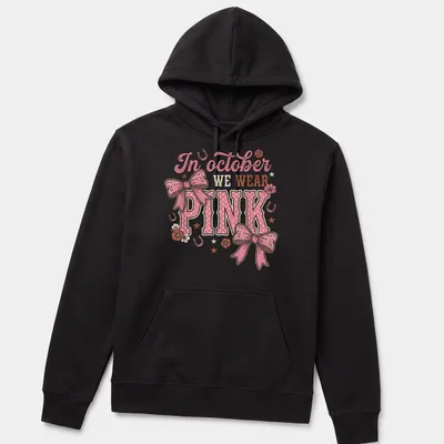 Playful T-shirt with a colorful Western bow and text about October wearing pink — printed on a unisex hoodie