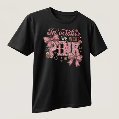 Playful T-shirt with a colorful Western bow and text about October wearing pink — printed on a unisex t-shirt (angled view)