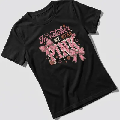 Playful T-shirt with a colorful Western bow and text about October wearing pink — printed on a women's shirt