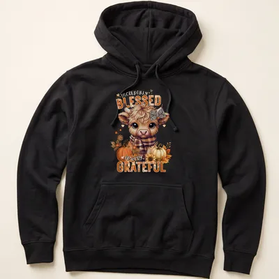 Kawaii Highland cow design with colorful text expressing gratitude — printed on a unisex hoodie