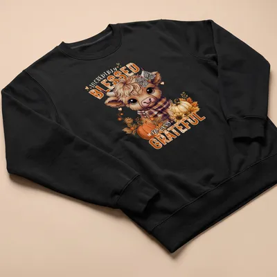 Kawaii Highland cow design with colorful text expressing gratitude — printed on a unisex sweatshirt