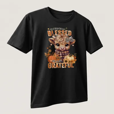 Kawaii Highland cow design with colorful text expressing gratitude — printed on a unisex t-shirt (angled view)