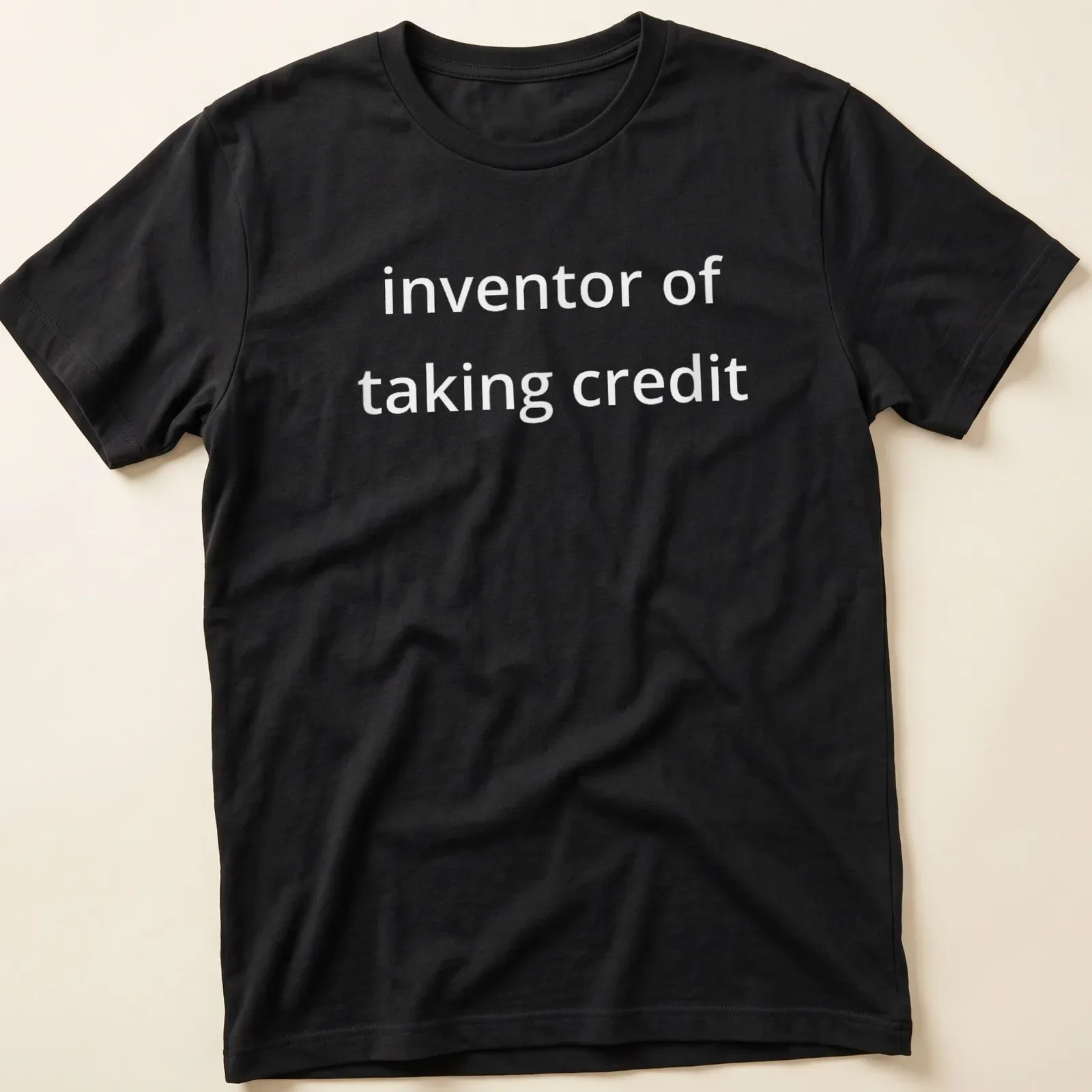 Bold text saying 'inventor of taking credit' on a — printed on a unisex t-shirt