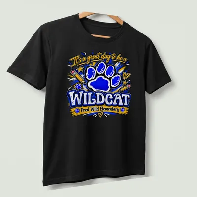 Playful illustration of a wildcat paw print with colorful text for school pride — printed on a unisex t-shirt (angled view)